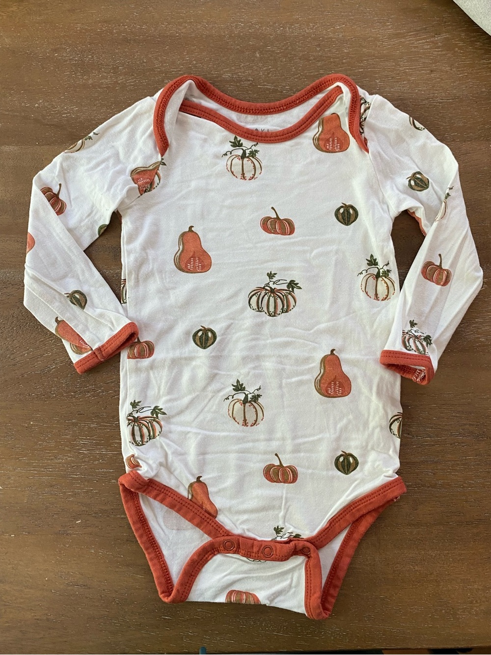 Kyte BABY long sleeve bodysuit in ”Pumpkin” 12-18 mo, EUC